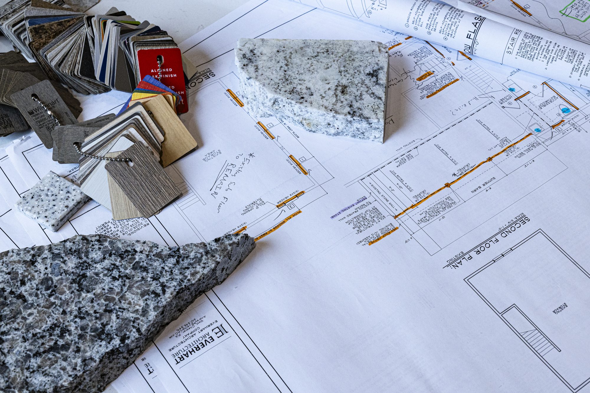 Floor plans and finish samples on a conference table